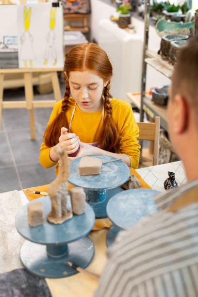 istock Girl feeling curious modeling animals with clay for the first time 1152050084