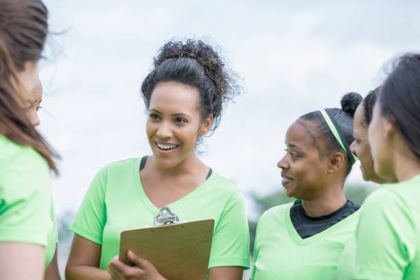 istock Team captain talking with diverse group of women at sporting event 1152051829
