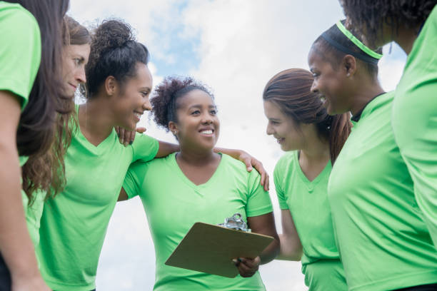 istock Athletic women discuss play while huddled on sidelines during team sports event 1152051956