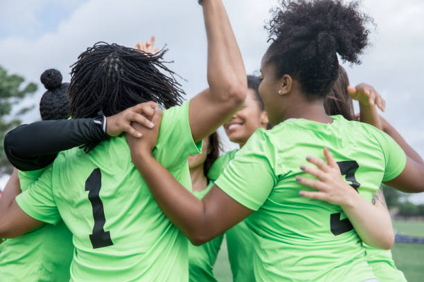 istock Women celebrate winning team sporting event together in a huddle 1152051988