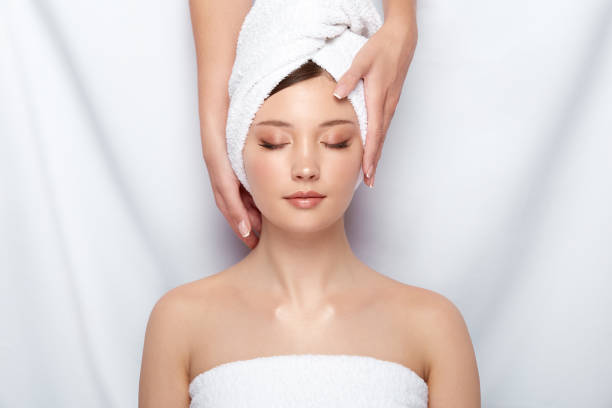 istock attractive woman lying down on spa theraphy in bath towel 1152052414