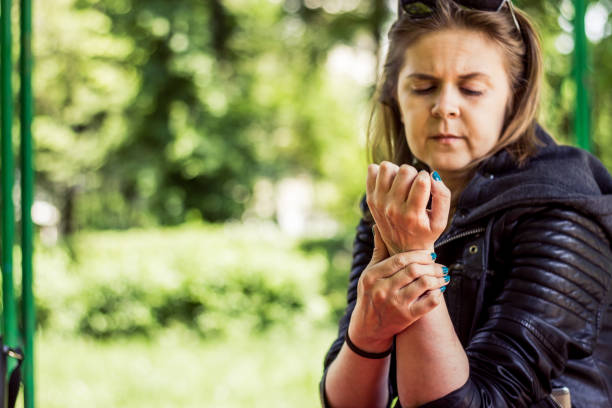 istock Girl with deformed hand holding by her wrist 1152053820