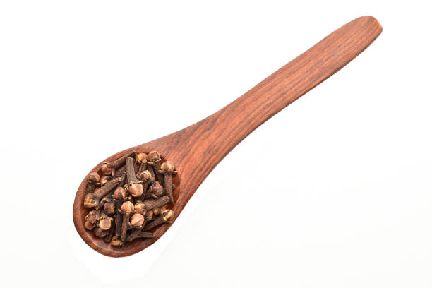 istock clove buds in wooden spoon isolated on white background 1152055829