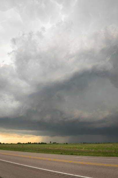 istock Stormy sky over the road. Severe warned thunderstorm over the Nebraska plains. 1152055942