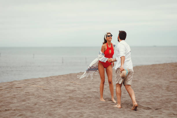 istock Young loving couple enjoys the beach 1152056185