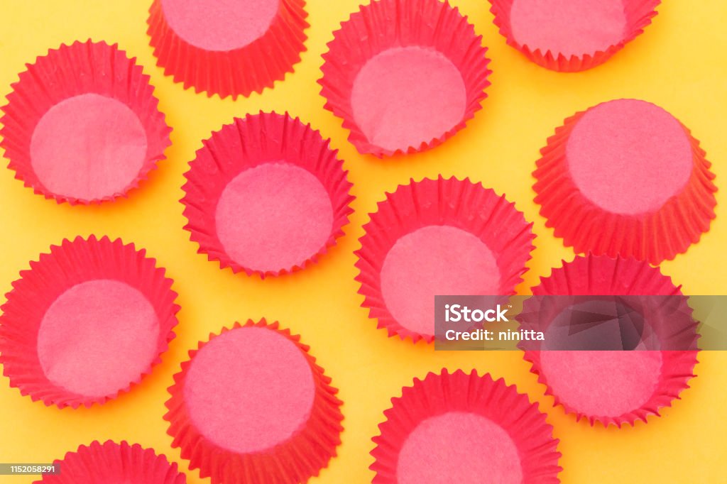 empty muffin cake paper cup for cupcakes isolated on orange background Algeria Stock Photo empty muffin cake paper cup for cupcakes isolated on orange background Algeria Stock Photo