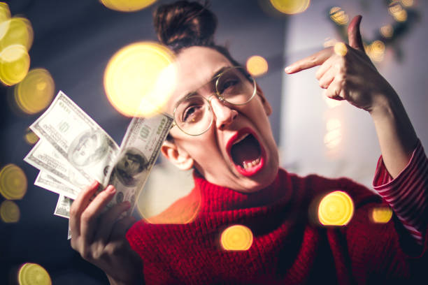 istock Excited hipster woman and flying dollar bills 1152064744