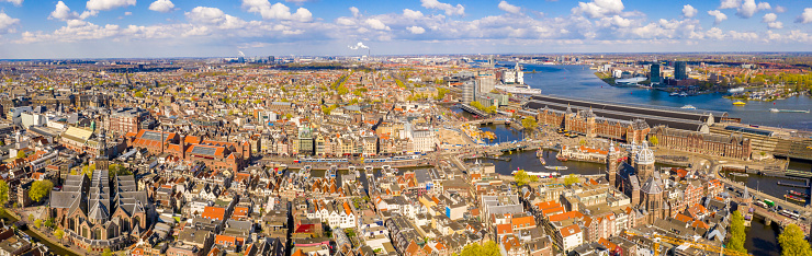 Beautiful aerial Amsterdam view from above with many narrow canals, streets and architectures.