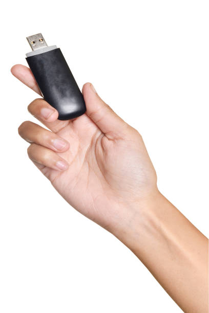 istock dongle in woman's hand isolated in white background 1152064876