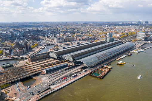 Aerial view of Central Station. The name of Amsterdam is written in huge letters on the roof of the central station.