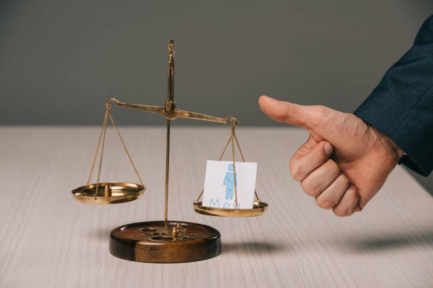 partial view of businessman showing thumbs up near scales of justice and male signs, gender stereotypes concept - human hand hand sign measuring scale imagens e fotografias de stock