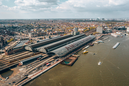 Aerial view of Central Station. The name of Amsterdam is written in huge letters on the roof of the central station.