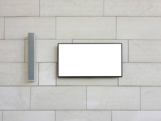istock Front view LCD television (clipping path) with loudspeaker hanging on outdoor wall background 1152067395