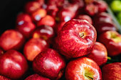 Delicious red apples on retail display at supermarket