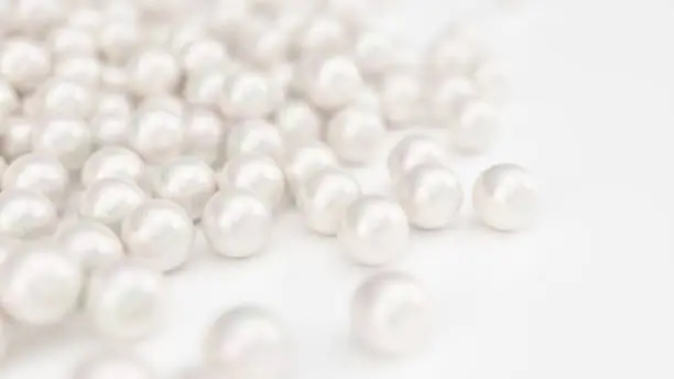 Photo of Pile of pearls. Background of the plurality of beautiful pearls. Gems, women's jewelry, nacre beads. Background For your banner, poster, logo. Beautiful shiny sea pearl. 3d illustration