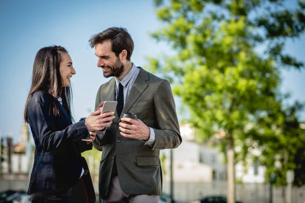istock colleagues at a break talk about work in front of a business building 1152075837
