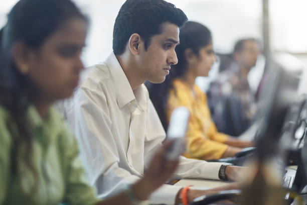 istock Businessman working amidst colleagues at office 1152076957