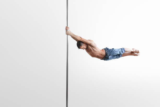 istock Pole Dance male athlete on the white background 1152077033