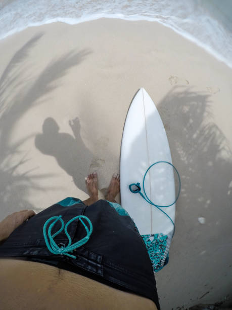 istock Surfer looking down at his surfboard personal perspective (POV) 1152077639