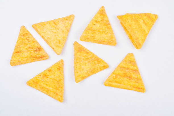 istock nacho chips isolated on white background, unhealthy junk food 1152077817