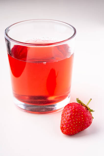 istock One strawberry with compote drink in glass isolated on white background 1152078065