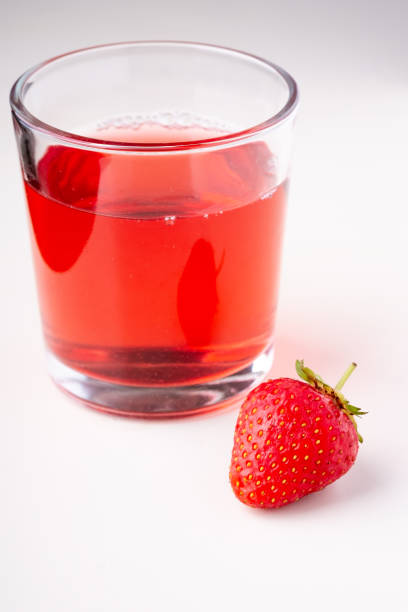 istock One strawberry with compote drink in glass isolated on white background 1152078113