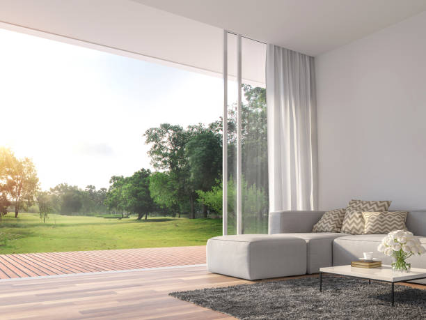 Modern living room with large open door to nature 3d render Modern living room 3d render.The Rooms have wooden floors ,decorate with white fabric sofa,There are large open sliding doors, Overlooks wooden terrace and big garden. thai door stock pictures, royalty-free photos & images