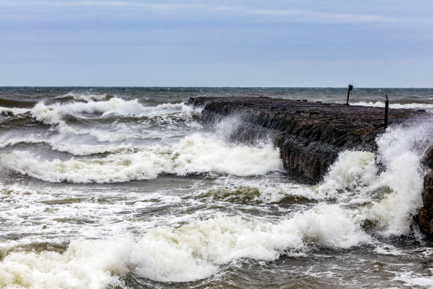 istock Waves hitting the pier. Storm on the sea 1152080616