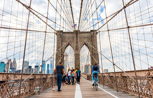 NEW YORK, USA - September 28, 2018: BROOKLYN BRIDGE in New York. Tourists walking on the Brooklyn Bridge. New York City, USA.