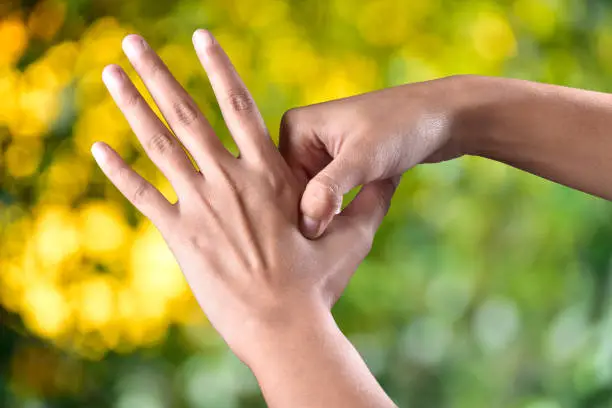 Photo of acupressure, self medication concept in outdoor sunlight