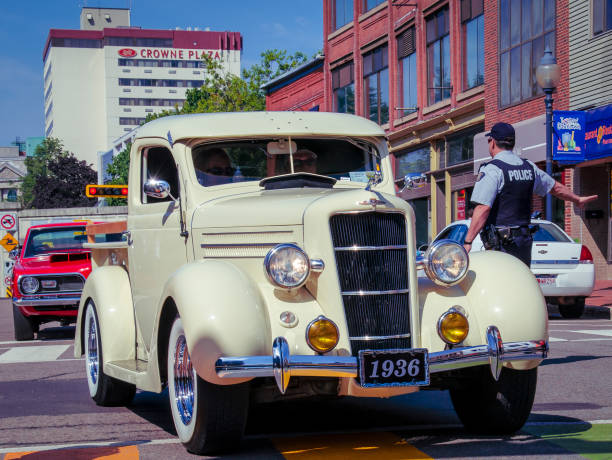 Budapest, Hungary - May 1, 2024: Promenade of old timer cars through the Dozsa Gyorgy street in central Budapest. Parade is held annually on the Labor Day when owners drive their old timer vehicles followed by old timer buses and trucks.