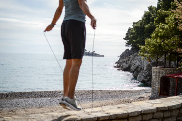 istock Fit man jumping rope at the beach 1152085814