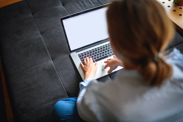 istock Mid Adult Woman Using Laptop Computer 1152085851