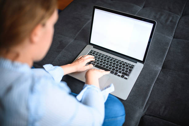 istock Mid Adult Woman Using Laptop Computer 1152085887