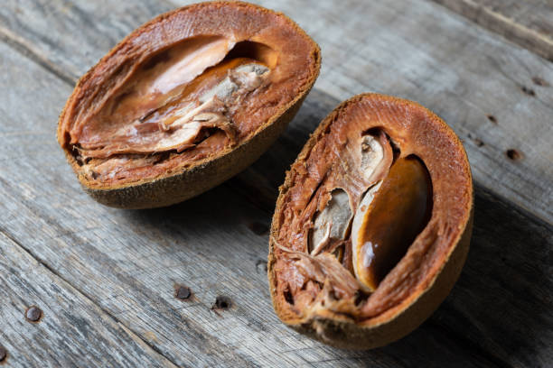 istock Ripe mamey fruit with seed on wood background 1152086663