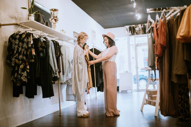 Latina Boutique Store Owner Assisting Customer stock photo