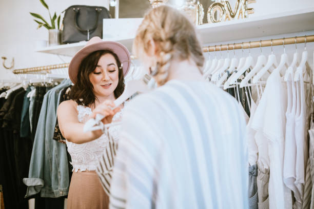 istock Latina Boutique Store Owner Assisting Customer 1152091086