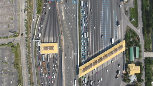 Aerial Top View Over Expressway Toll Gate with Many Vehicles Passing Through and Pay Fee