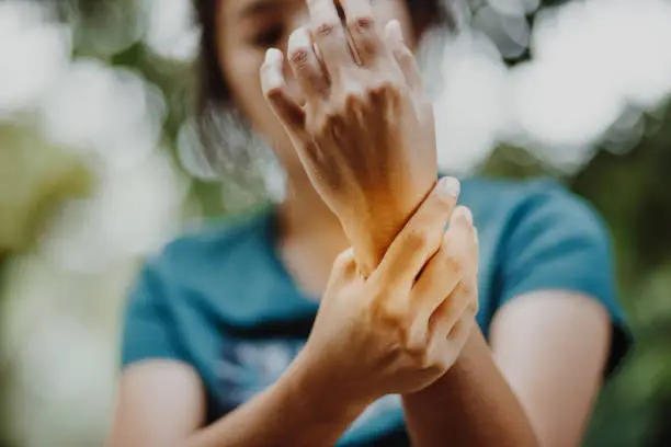 Photo of Close up young woman Left wrist pain , office syndrome , health care concept