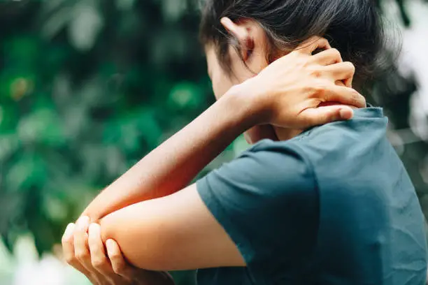 Photo of young women having pain in injured arm , office syndrome , health care concept