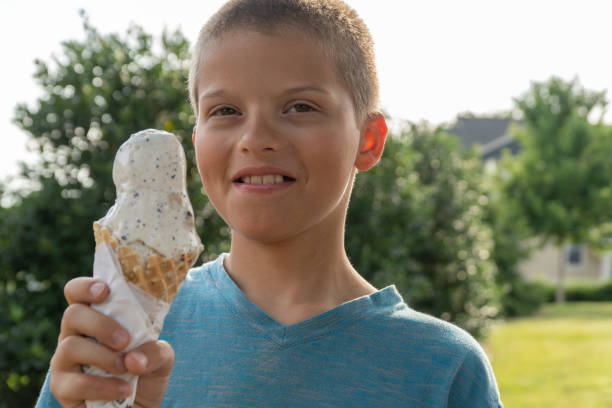 istock Boy eating ice cream on a waffle cone. 1152097619