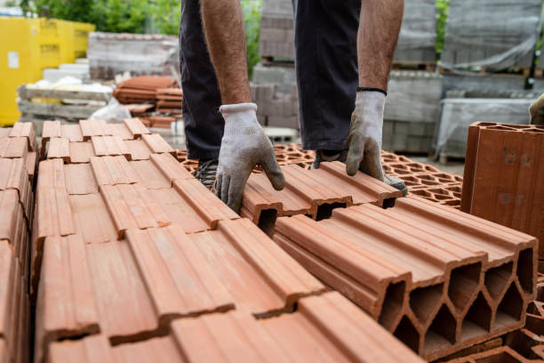 istock Construction worker loading material in the lorry truck at the warehouse for the building site clay brick blocks 1152097869