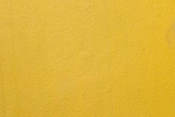 istock yellow cement wall background close up 1152098655