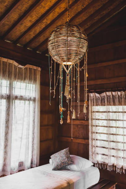 istock Handmade decorative wicker lamp in wooden house ethnic style 1152098864
