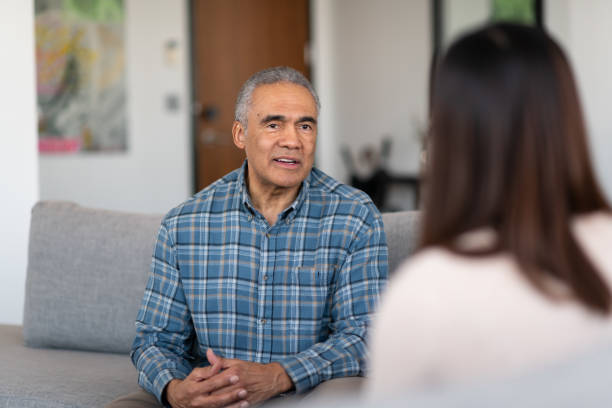 an elderly married man at couple's therapy - arguing senior adult conflict couple imagens e fotografias de stock