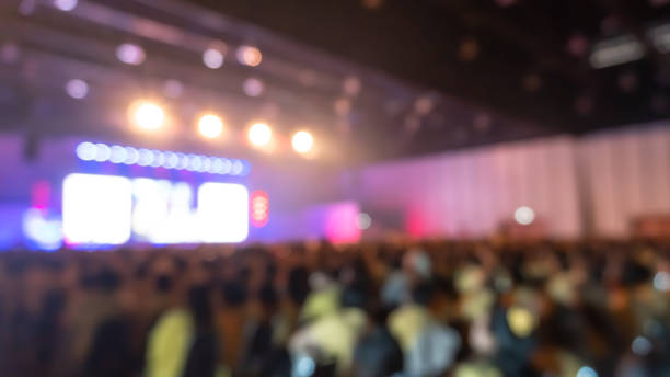 stage show blur background with crowd audience in theatre hall  and lighting bokeh for concert event or music performance - concert hall crowd dancing nightclub imagens e fotografias de stock