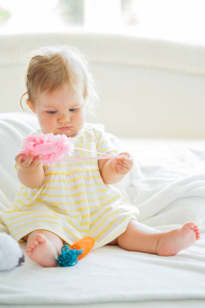 istock Baby girl playing with party hat 1152101541