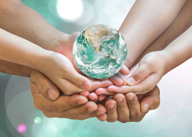 Green globe in family volunteer hands for earth day and CSR with people concept. Elements of this image furnished by NASA. Green globe in family volunteer hands for earth day and CSR with people concept. Elements of this image furnished by NASA. ozone layer photos stock pictures, royalty-free photos & images