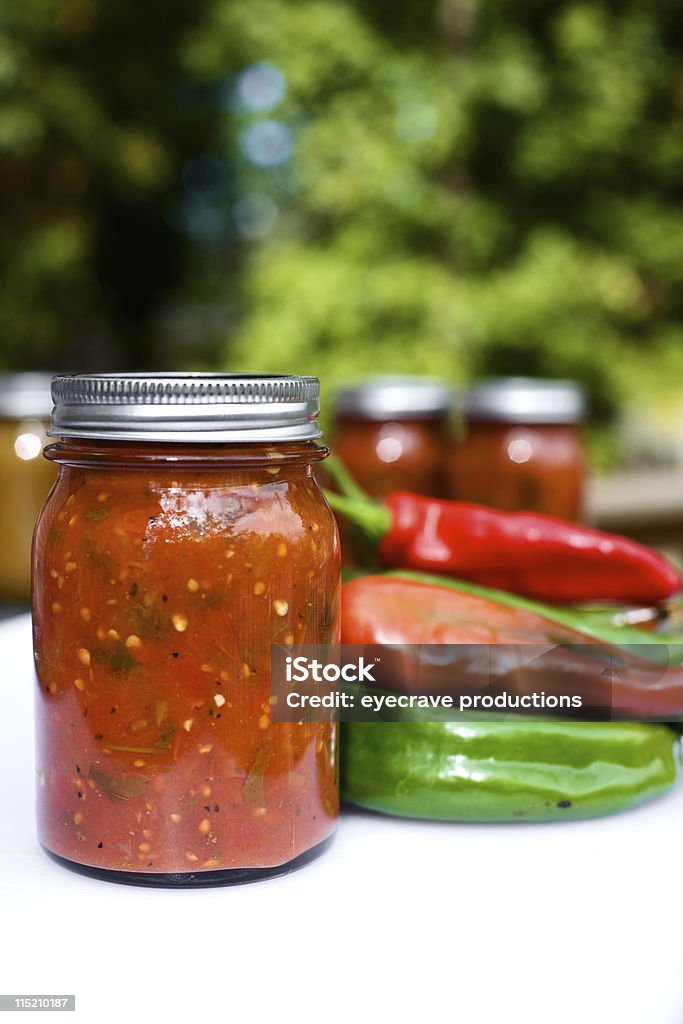 canned spicy mexican salsa canned salsa from fresh tomato, pepper, cilantro,garlic,onion vegetables red and green Anaheim chili peppers Homemade Stock Photo