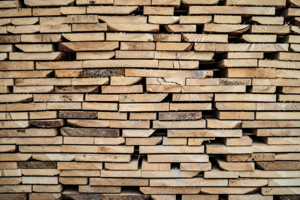 istock Close up on stack of rough sawn timber pine lumber planks construction material 1152105556